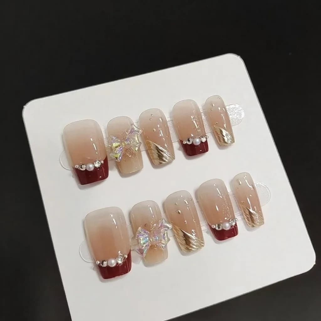 Short French Tip Press-On Nails with Gold Glitter and Bow Design