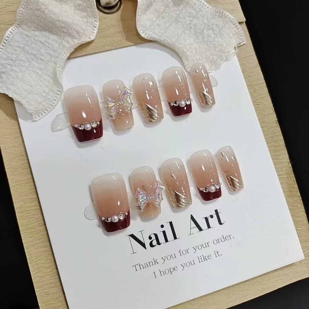 Short French Tip Press-On Nails with Gold Glitter and Bow Design